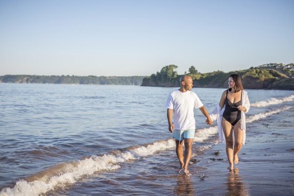 Couple enjoying a stroll on a South Devon beach