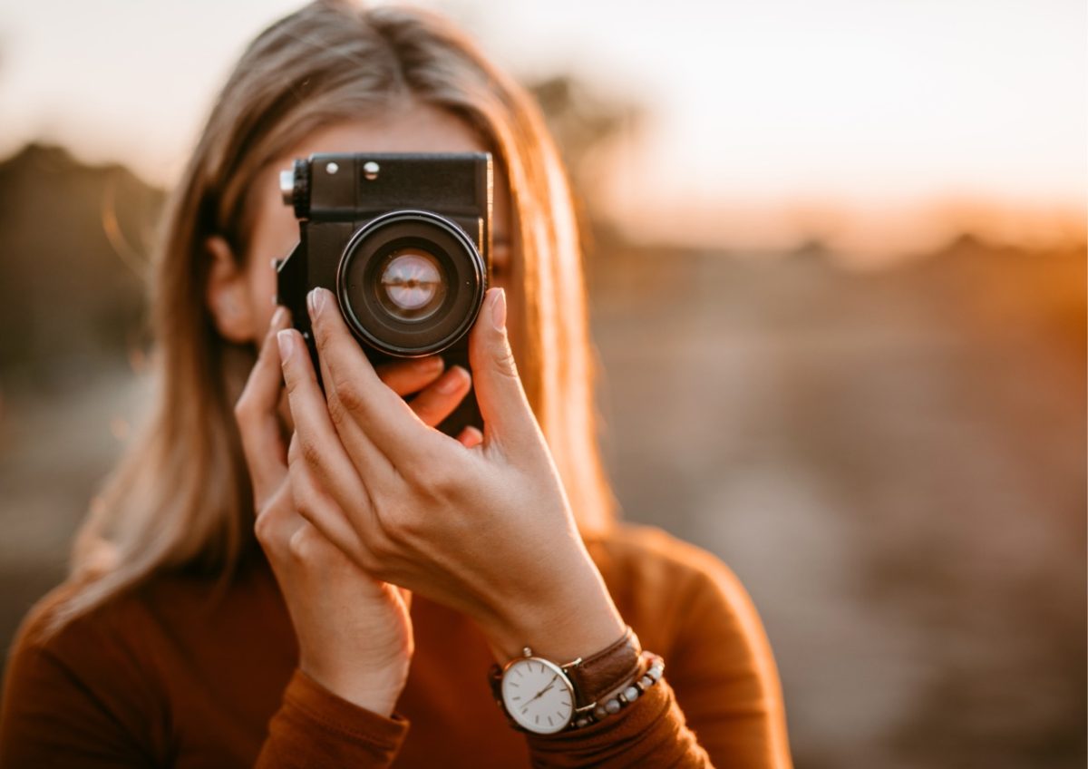 Photographer capturing the beauty of an Autumn sunset