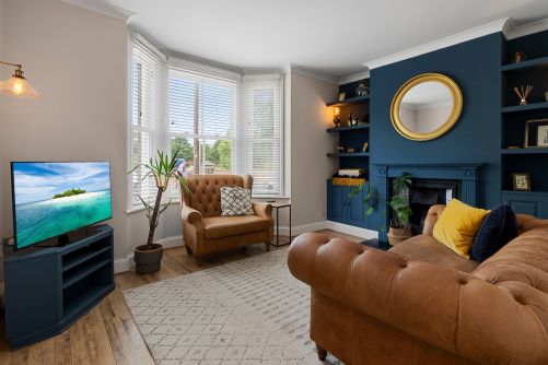 Contemporary holiday home lounge with a smart TV, comfortable seating, and stylish modern decor for relaxing evenings