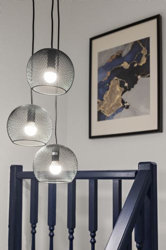 Contemporary holiday home landing featuring modern artwork on the wall and elegant pendant lighting for a sophisticated look