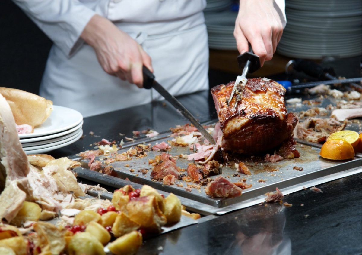 Chef in a South Devon restaurant preparing a joint of eat for traditional Sunday lunch