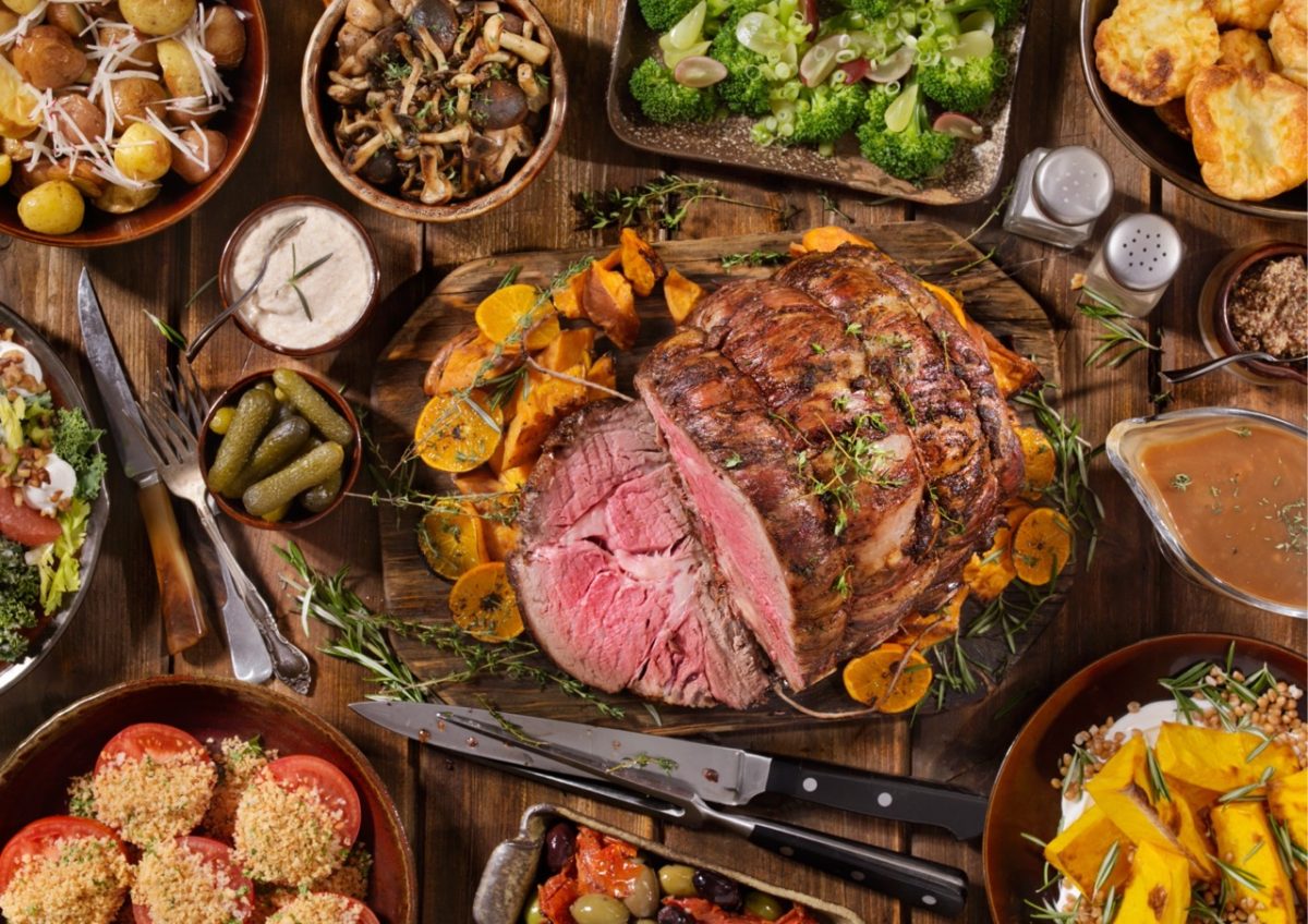 A traditional Sunday lunch roast spread on a pub's wooden table