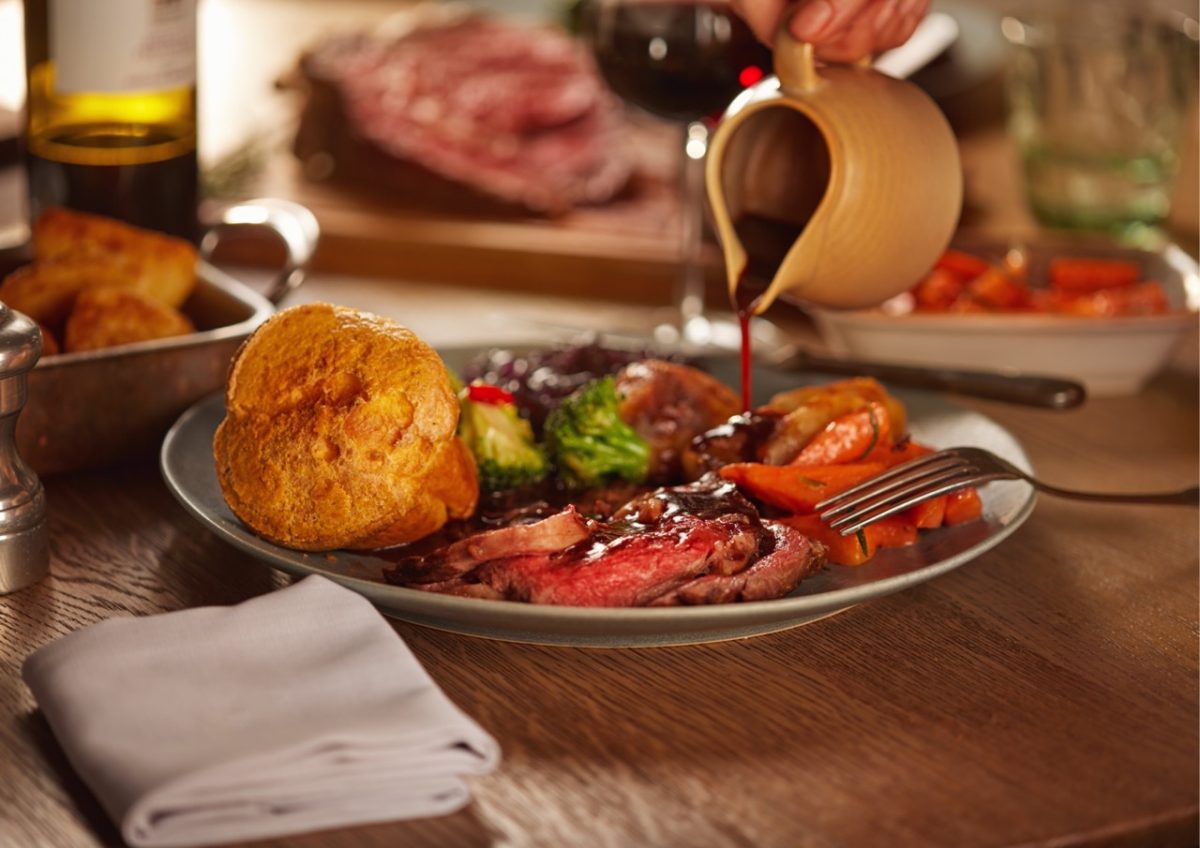 Traditional Sunday roast dinner with Yorkshire pudding and vegetables in South Devon pub