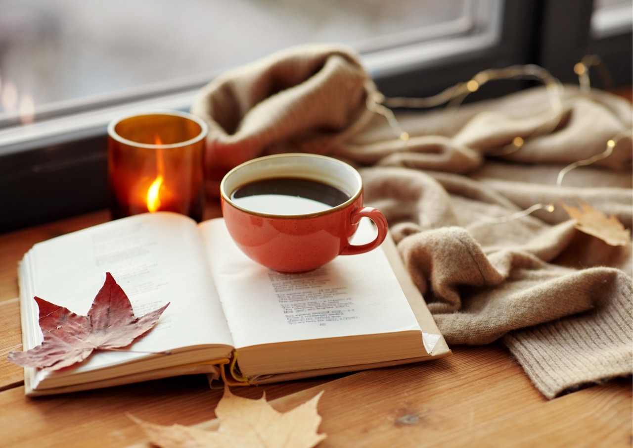 A cup of warming coffee, a scented candle and a throw to wrap up in during your autumn/winter break
