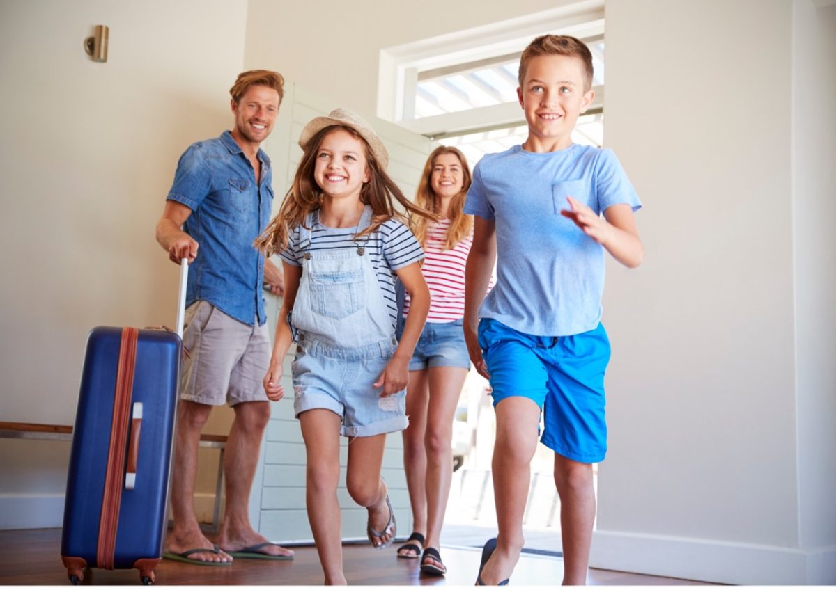 Family arriving at a seaside holiday home in South Devon.