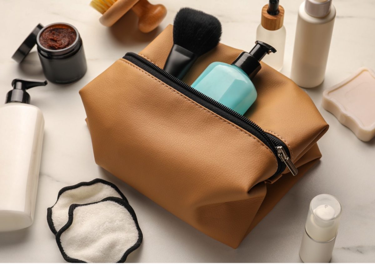 Neatly packed wash bag with soap, shampoo, and toothpaste on a bathroom counter