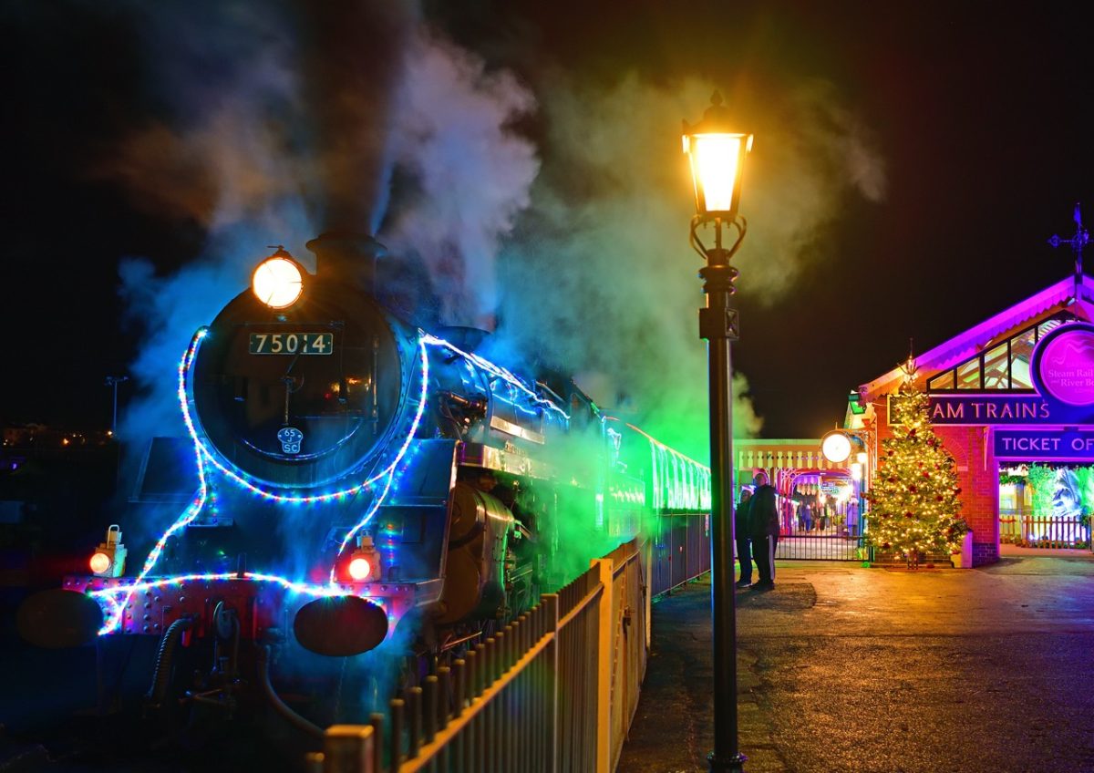 The Train if Lights steam train covered in twinkling Christmas lights  ready to depart the station as part of the Bay of Lights Festival in South Devon
