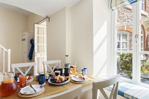 Breakfast laid out on a kitchen table in a holiday cottage.