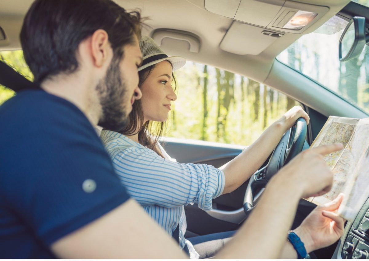 A couple following directions in the car to their South Devon holiday home