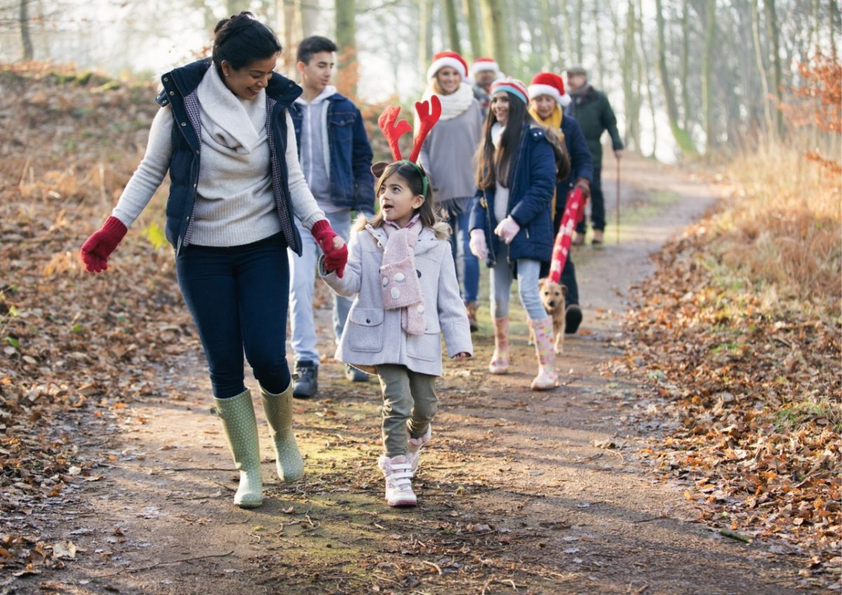 Friends and family enjoying a Winter walk in South Devon wearing Christmas hats and antlers