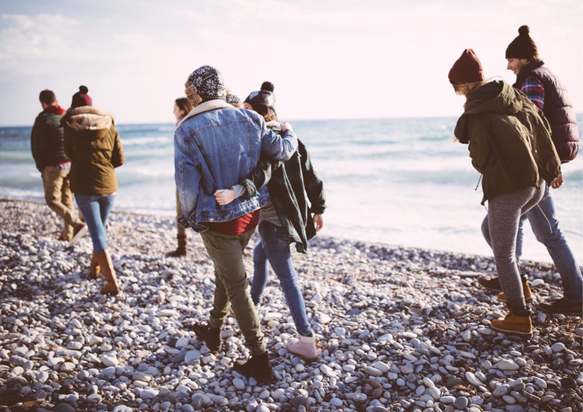 Friends and family enjoying a winter beach walk in South Devon
