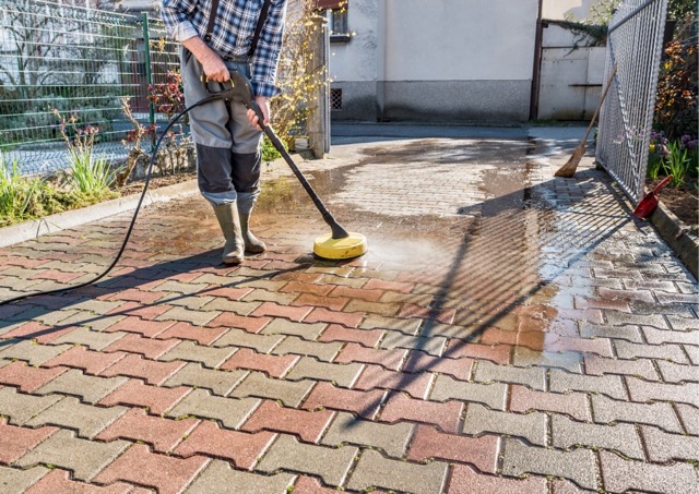 Driveway being jet washed to maintain exterior areas of a Devon holiday property.