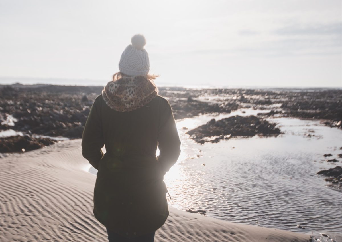 A woman enjoying a winter walk along the South West coast path
