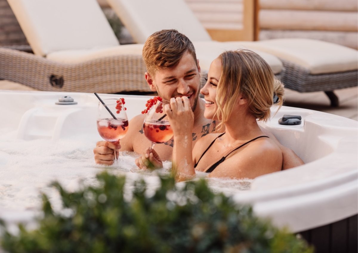 A couple relaxing in a hot tub in South Devon