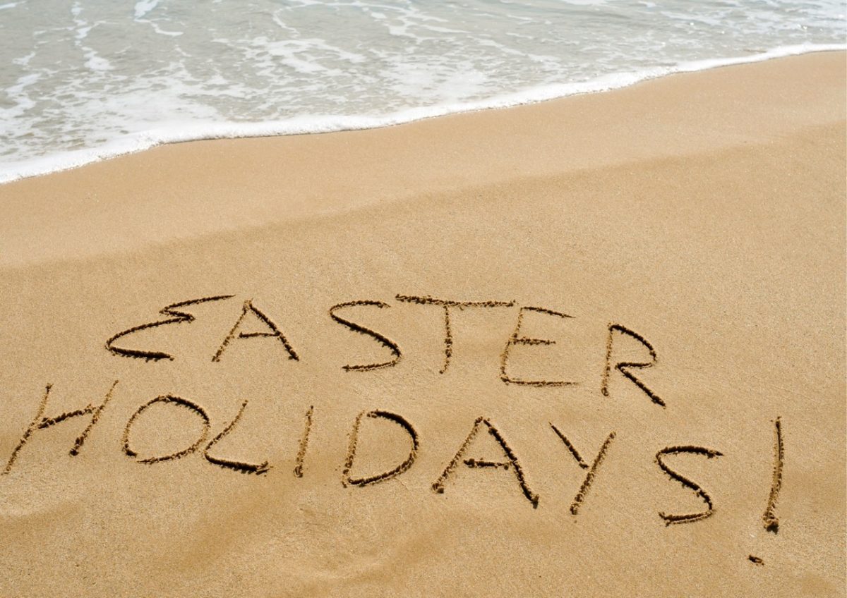 Easter Holidays written in sand on a South Devon beach
