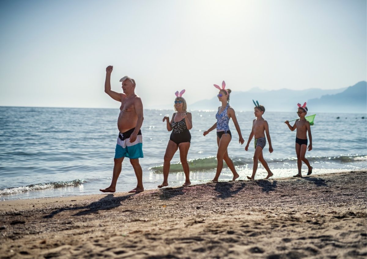 Family enjoying a walk on the beach at Easter